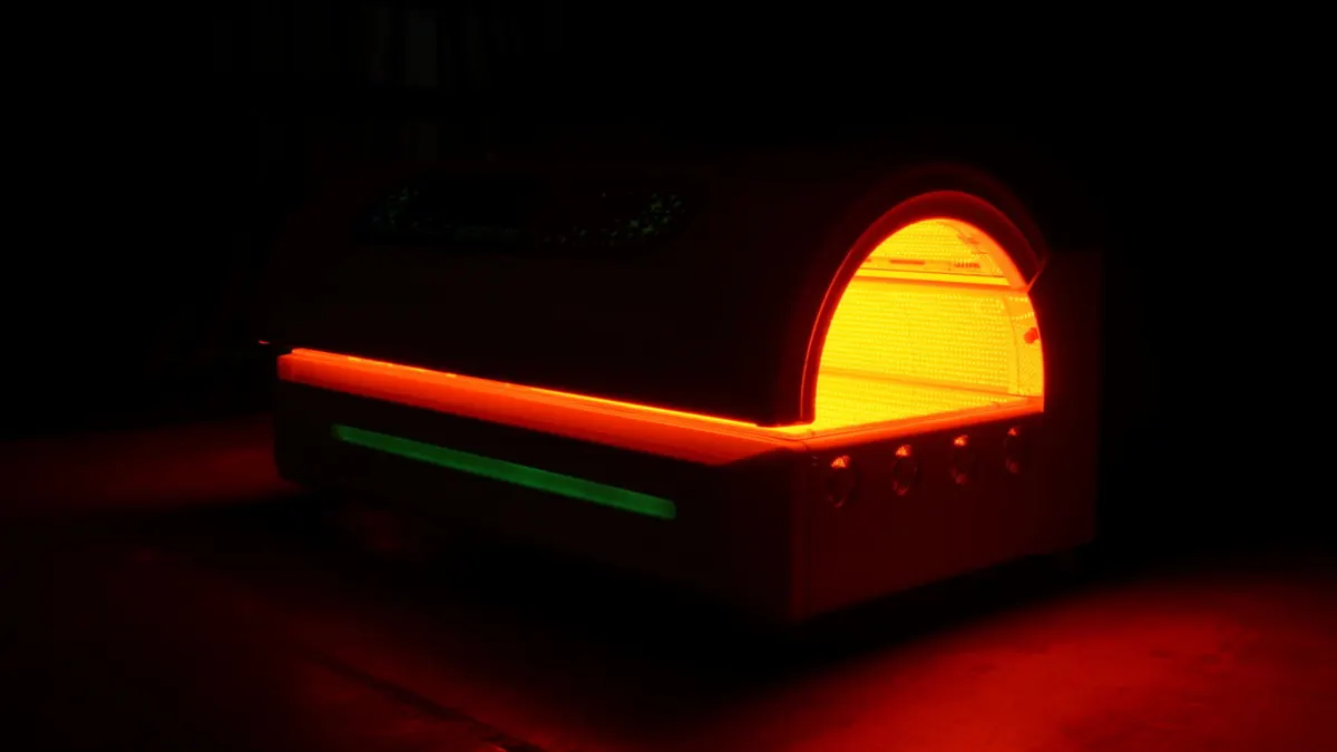 Mito Prime bed glowing with red light and colored accent lighting in a dark treatment room